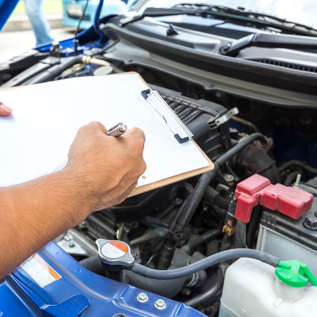 St Michael's Street Garage mechanic with clipboard